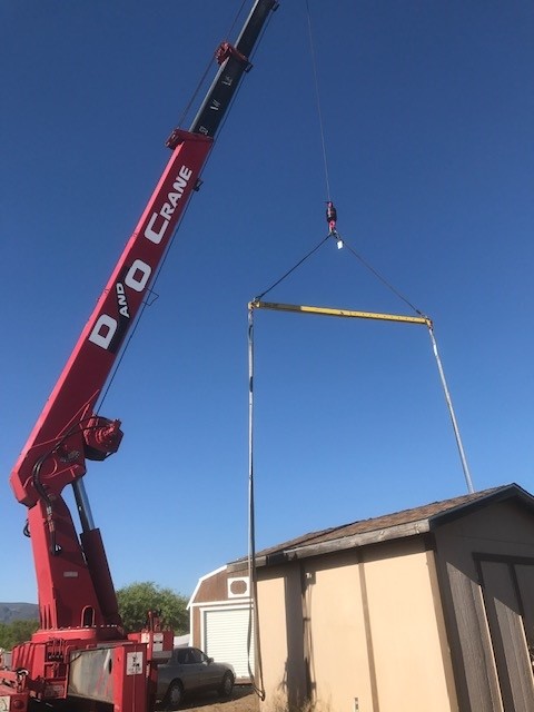 D&O Crane lifting a small building with a spreader bar in Northern Arizona.