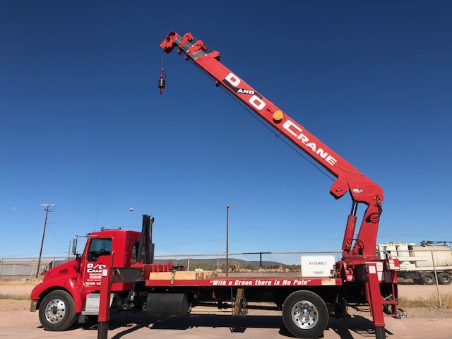 Red D&O Crane truck with mounted boom crane ready for lifting services in Northern Arizona.